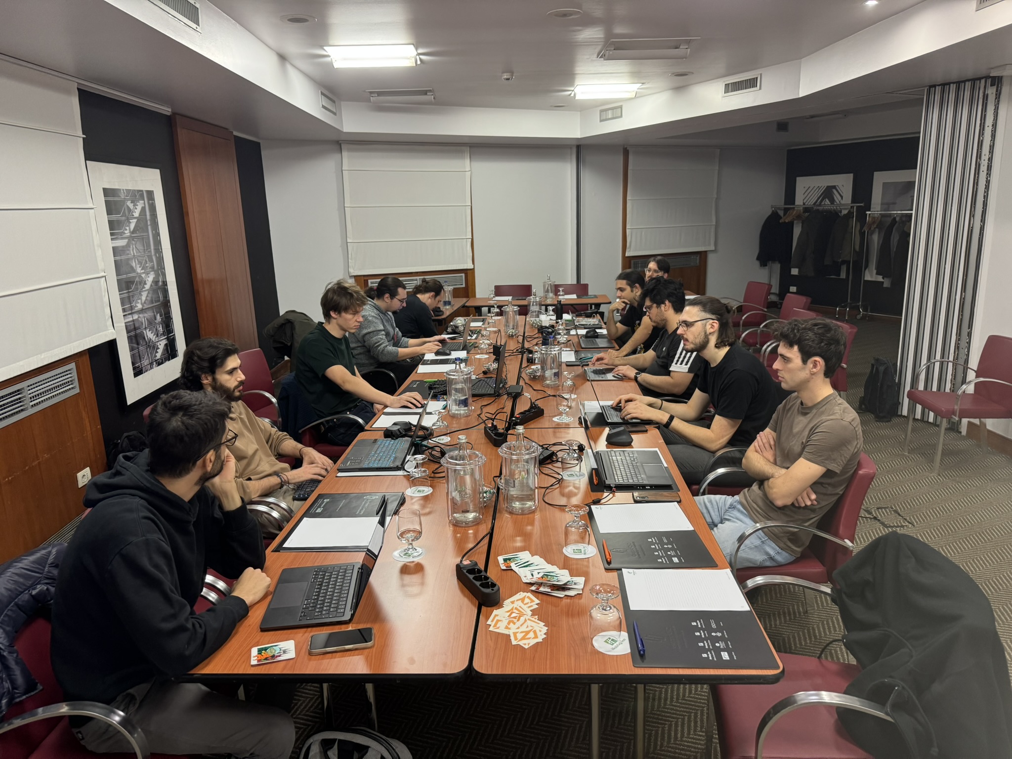 Group photo of attendees during the morning session, all sitting together at the shared table